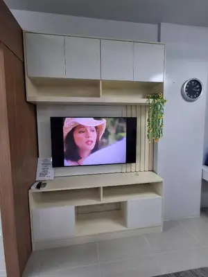 a television in a entertainment center in a living room at idyllic Apartment for Rent - Perfect for Short-Term Stay Front of Mall of Asia in Manila