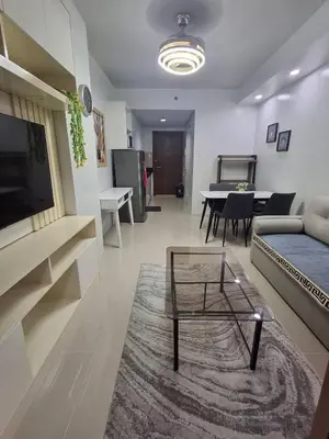 a living room with a couch and a table at idyllic Apartment for Rent - Perfect for Short-Term Stay Front of Mall of Asia in Manila