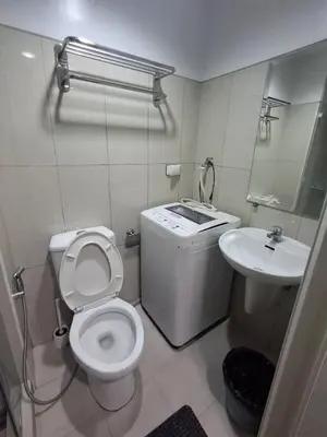 a bathroom with a toilet and a sink at idyllic Apartment for Rent - Perfect for Short-Term Stay Front of Mall of Asia in Manila