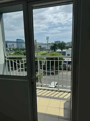 a view of a balcony from an open door at Chic Retreat in Pasay City - Scandinavian with Balcony facing Mall Of Asia in Manila