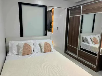 a bedroom with a large white bed with a large window at Chic Retreat in Pasay City - Scandinavian with Balcony facing Mall Of Asia in Manila