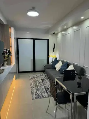 a living room with a couch and a table at Chic Retreat in Pasay City - Scandinavian with Balcony facing Mall Of Asia in Manila