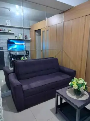 a living room with a purple couch and a table at Peaceful Pasay Oasis - Entire Apartment for Rent in Manila