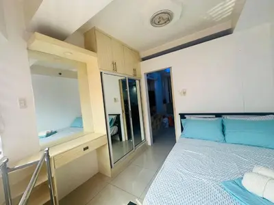 a small bedroom with a bed and a mirror at Xenial Pasay City Apartment for Rent - Entire House Front of Mall of Asia in Manila