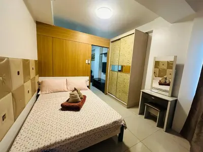 a small bedroom with a bed and a mirror at Dainty Pasay City Apartment for Rent - Entire House Front of Mall of Asia in Manila