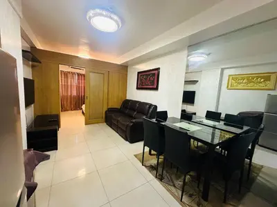 a living room with a couch and a table at Dainty Pasay City Apartment for Rent - Entire House Front of Mall of Asia in Manila