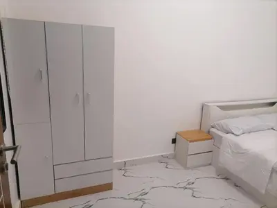 a bedroom with a bed and a dresser and a mirror at Navio Transient House in Cabuyao