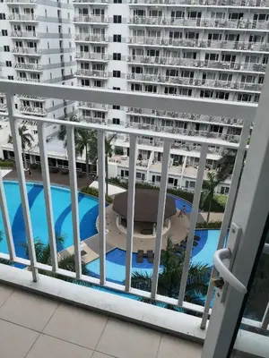 a balcony with a view of a large apartment building at Fancy Pasay City Apartment for Rent - Mall of Asia Nearby front of Mall Of Asia in Manila
