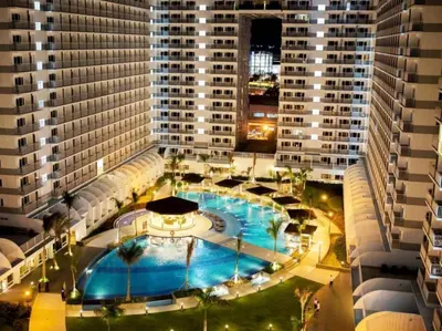 an overhead view of a large building with a swimming pool at Fancy Pasay City Apartment for Rent - Mall of Asia Nearby front of Mall Of Asia in Manila