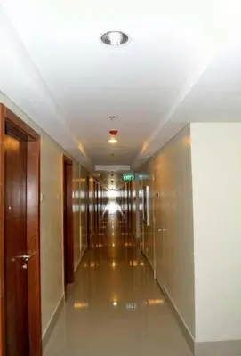 an empty hallway in a building with a hallway at Joyful Pasay Getaway Staycation Condo Near MOA and IKEA near Mall of Asia in Manila
