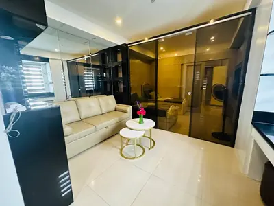 a living room with a couch and a table at Quaint 2BR Connected Apartment in Pasay City - Perfect for Families front of MOA in Manila
