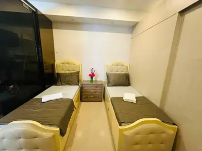 two beds in a small room with sidx sidx sidx sidx at Quaint 2BR Connected Apartment in Pasay City - Perfect for Families front of MOA in Manila