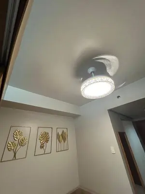 a ceiling light in a room with pictures on the wall at Vibrant Pasay City Apartment for Rent - Perfect Home Base front of Mall of Asia in Manila