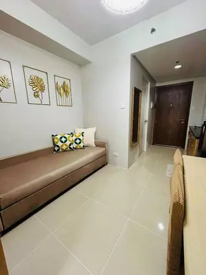 a living room with a couch in a room at Vibrant Pasay City Apartment for Rent - Perfect Home Base front of Mall of Asia in Manila