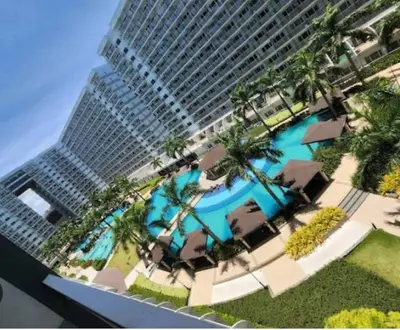 a view of a building with a swimming pool and a building at Vibrant Pasay City Apartment for Rent - Perfect Home Base front of Mall of Asia in Manila