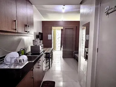 a kitchen with a sink and a counter top at Kempt Pasay City Apartment for Rent - Perfect for Short-Term Stay front of MOA in Manila
