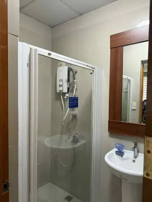 a bathroom with a shower and a sink at La Belladoza near Airport in Manila