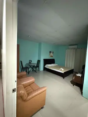 a room with a bed and a couch and a table at La Belladoza near Airport in Manila