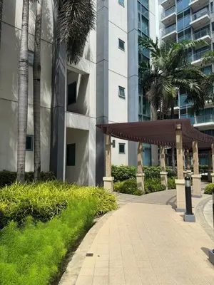 a walkway in front of a building with palm trees at Kai cabins WALKING DISTANCE NAIA 3 AIRPORT NEWPORT CITY in Manila
