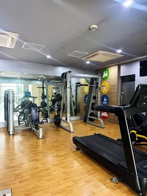 a gym with several tread machines in a room at Kai cabins WALKING DISTANCE NAIA 3 AIRPORT NEWPORT CITY in Manila
