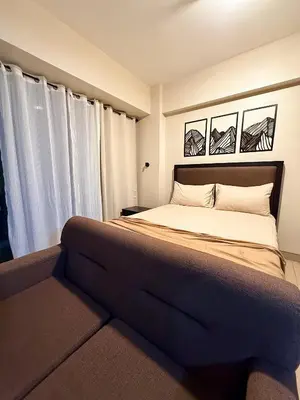 a bedroom with a large bed and a window at Kai cabins WALKING DISTANCE NAIA 3 AIRPORT NEWPORT CITY in Manila