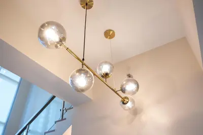a chandelier hanging from a ceiling in a room at BGC Spacious 1BR Loft Uptown in Manila