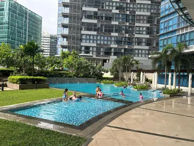 a group of people in a swimming pool in a city at BGC Spacious 1BR Loft Uptown in Manila