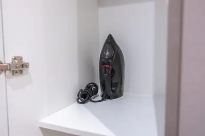 a pair of headphones sitting on a shelf next to a door at BGC Spacious 1BR Loft Uptown in Manila