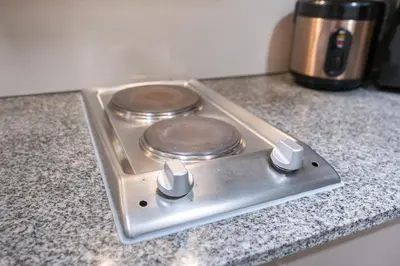a stove top with two burners on a counter at BGC Spacious 1BR Loft Uptown in Manila
