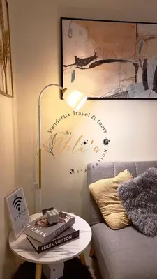 a living room with a couch and a table with a laptop at Yola's Staycation - Jazz Residences Makati City in Manila