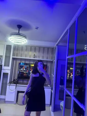 a woman in a black dress standing in a room at Esthetic vibes in Manila