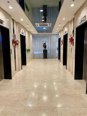a hallway in a building with a large lobby at Cordial Condo in Manila