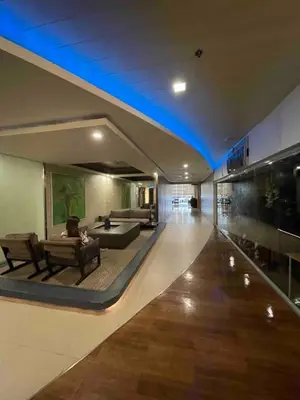 a living room with a couch and a table in a building at The Serenity Tower 3114 in Manila