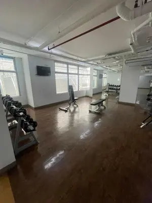 an empty room with a gym with chairs and weights at The Serenity Tower 3114 in Manila