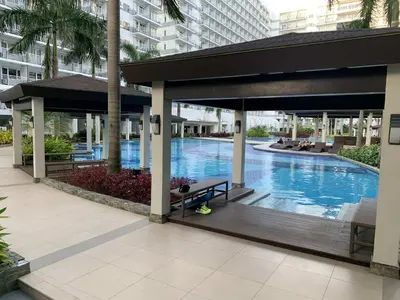 a pavilion with a swimming pool in a building at Shell Residence Pasay MOA with 2 Beds by G&K in Manila