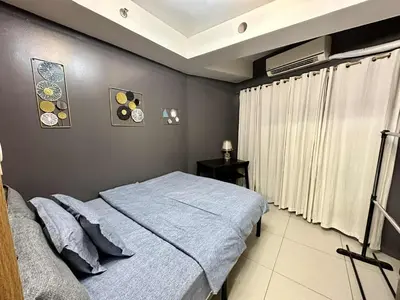 a bedroom with a blue bed and a window at Shell Residence Pasay MOA with 2 Beds by G&K in Manila