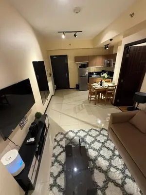 a large living room with a couch and a table at 1-Bedroom Condo - Stunning Sunset at the City in Manila