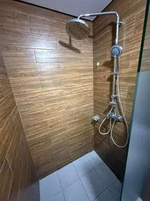 a bathroom with a shower with a shower head at 1-Bedroom Condo - Stunning Sunset at the City in Manila