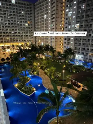 a view of a resort with palm trees and buildings at Le Luna Unit - Affordable Staycation near Airport & MOA with pool by Voyage Vista - Azure & Shore Staycation in Manila