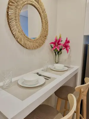 a white table with two plates and a mirror at Le Luna Unit - Affordable Staycation near Airport & MOA with pool by Voyage Vista - Azure & Shore Staycation in Manila