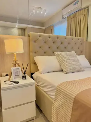 a bedroom with a large bed with a large headboard at Le Luna Unit - Affordable Staycation near Airport & MOA with pool by Voyage Vista - Azure & Shore Staycation in Manila