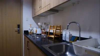 a kitchen with a sink and a counter top at Staycation in Marymount in Manila