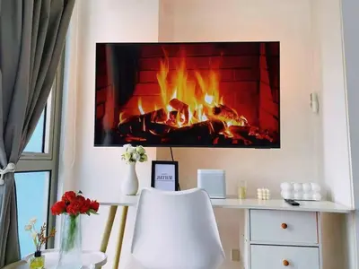 a desk with a fireplace in a room at Staycation in Marymount in Manila