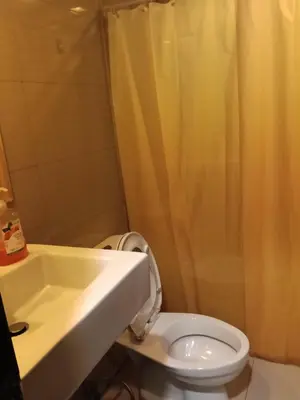 a bathroom with a toilet and a shower and a sink at McKinley Hills Taguig Haven in Manila