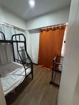 a room with two bunk beds and a window at J Suite in Manila