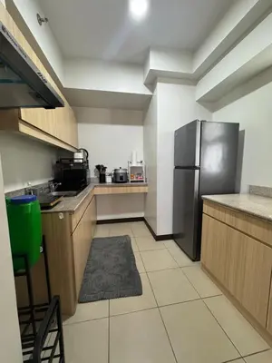 a kitchen with a stainless steel refrigerator and cabinets at J Suite in Manila