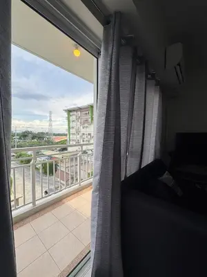 a room with a window with a view of a balcony at J Suite in Manila
