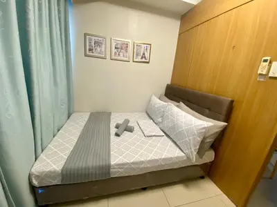 a small bed in a small room with a window at Cousins' Haven Staycation at SHELL RESIDENCES near MOA and NAIA in Manila