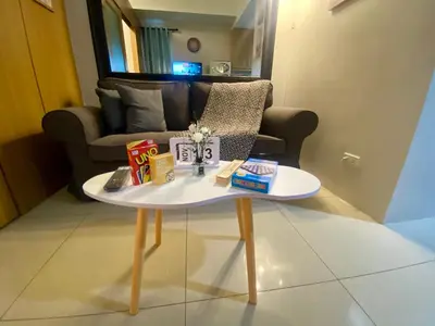 a coffee table in a living room with a couch at Cousins' Haven Staycation at SHELL RESIDENCES near MOA and NAIA in Manila