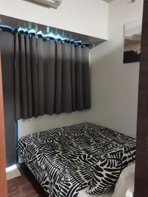 a bedroom with a zebra print bed and a window at 